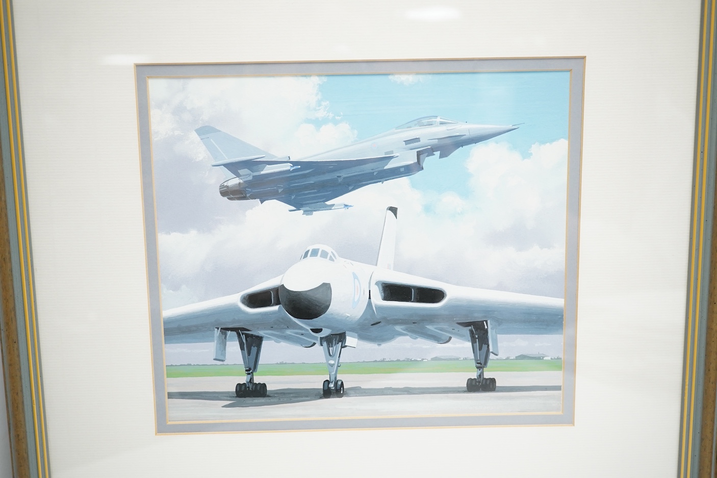 Keith Woodcock, an original gouache painting postage stamp design for an Isle of Man stamp featuring two RAF aircraft from different eras; the Avro Vulcan and the Eurofighter Typhoon, 20cm x 23.5cm, mounted and framed wi